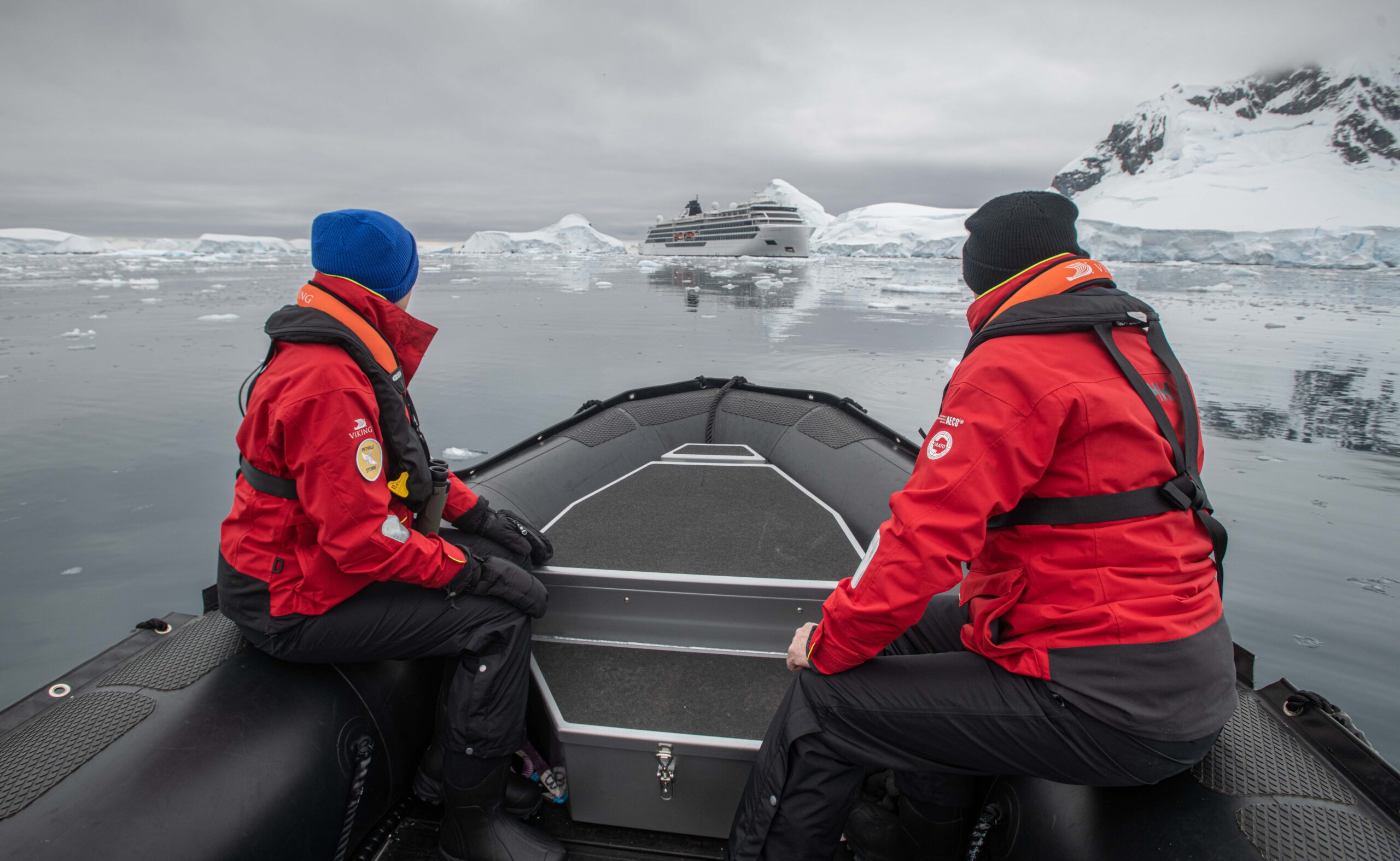 Couple on a zodiac approaching the Viking Octantis in Antarctica.